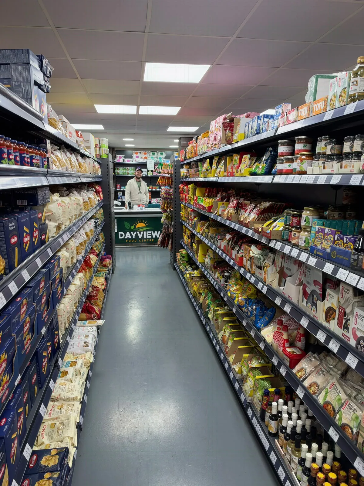 A stocked international grocery aisle inside Day View Food Centre in Andover